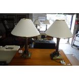 Pair of brass table lamps with tapered white shades