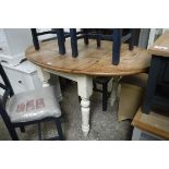 Cream painted kitchen table with oval pine drop side surface