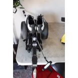 Golf trolley with putter and air of golf shoes, UK 8.5