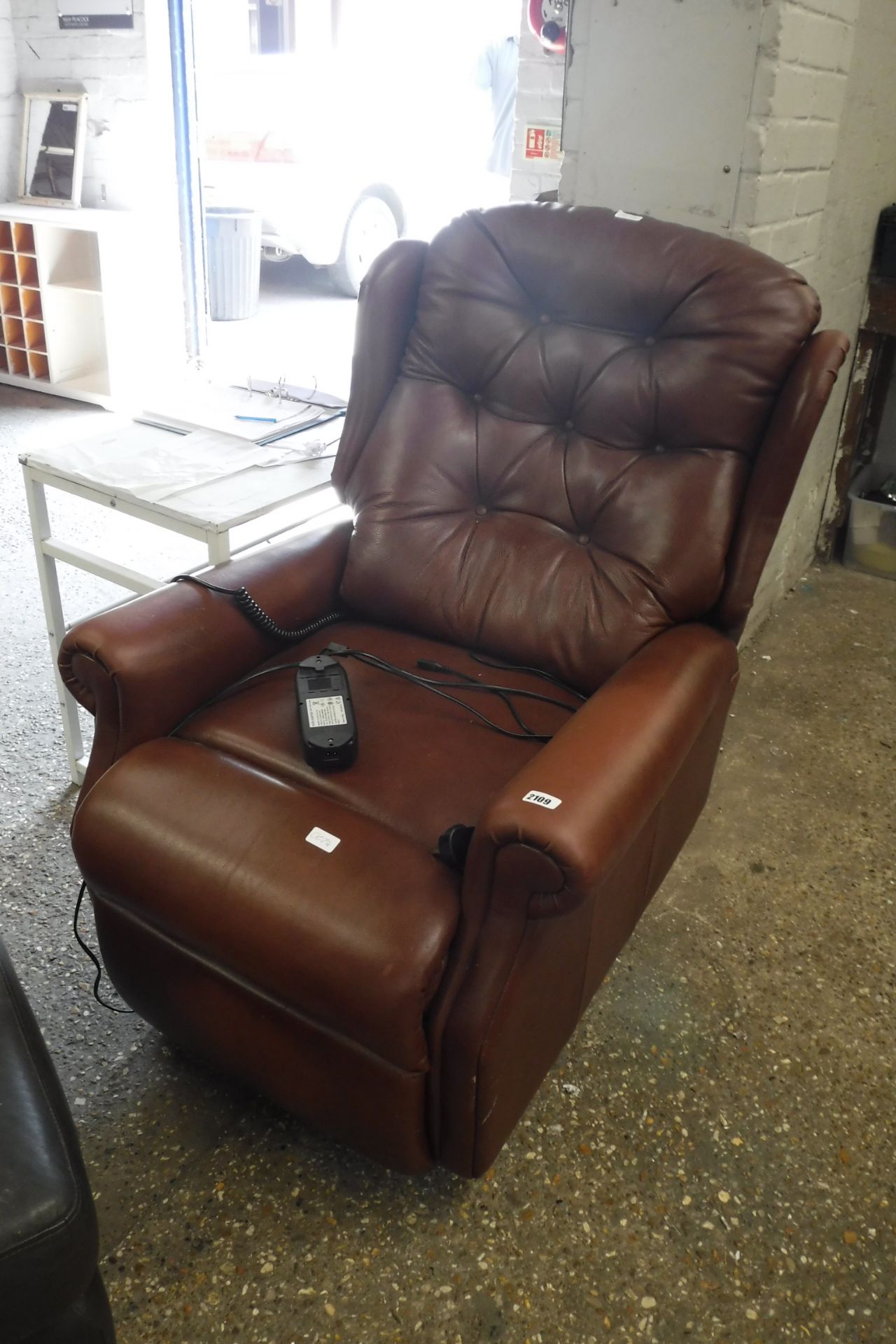 Brown leatherette upholstered wing back armchair with electrically assisted reclining