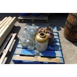 Selection of glass bottles and pottery jars on pallet