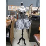 Mannequin with silver and black fabric ornamental dress