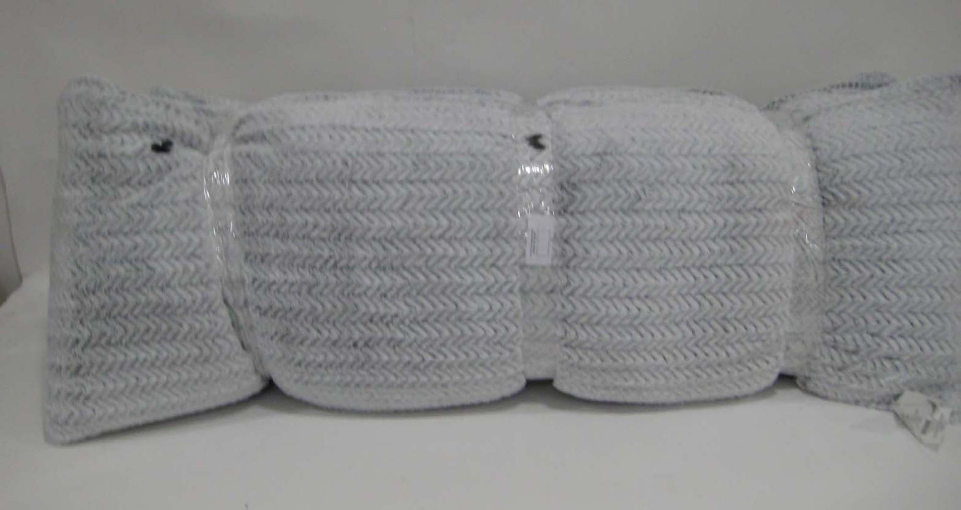 3 large grey faux fur covered bolster type pillows, one with some damage (see photos)