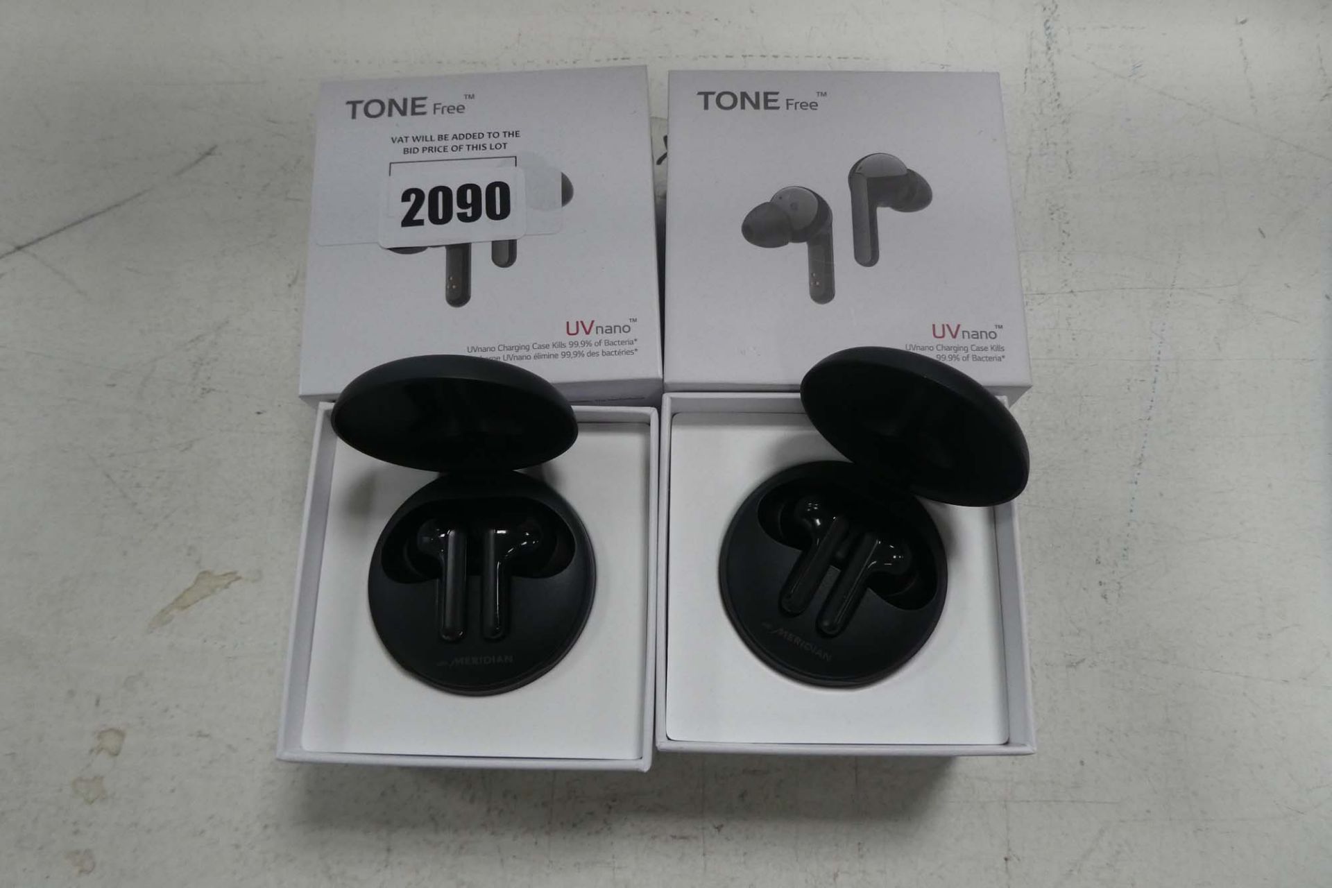 2 LG Tone Free UV Nano earbuds with boxes and chargers