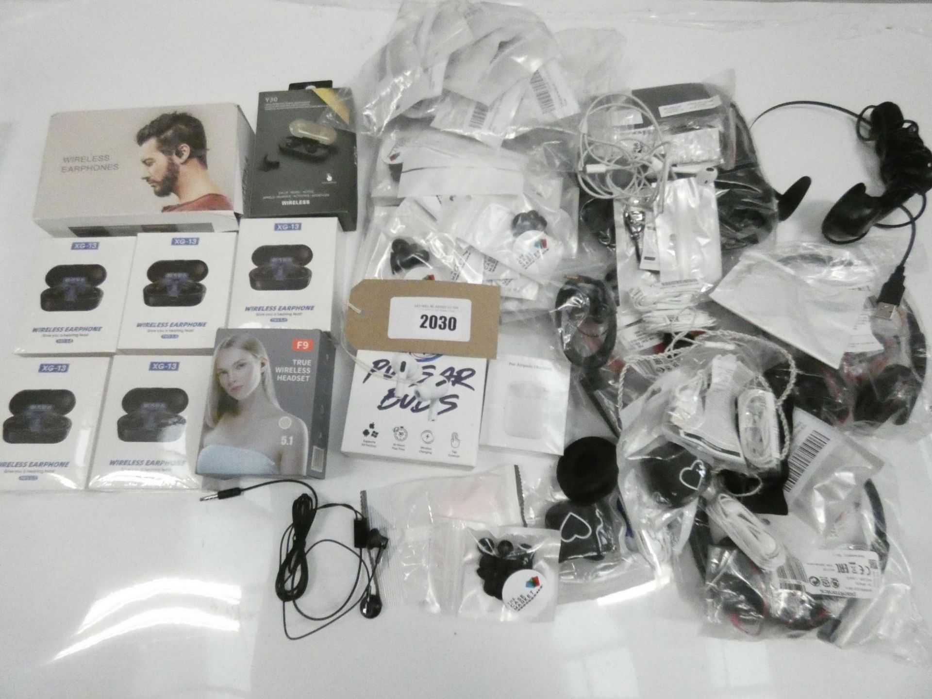 Bag containing various pairs of wireless earphones, wired headsets, earphones, earphone accessories