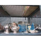 Cage containing a large quantity of silver plate to include teapots, candlesticks, bowl, cake