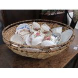 Wicker basket plus a quantity of rose and floral patterned crockery