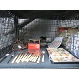 Cage containing mineral samples, Rhodesian banknotes, fish knives and forks, pair of binoculars