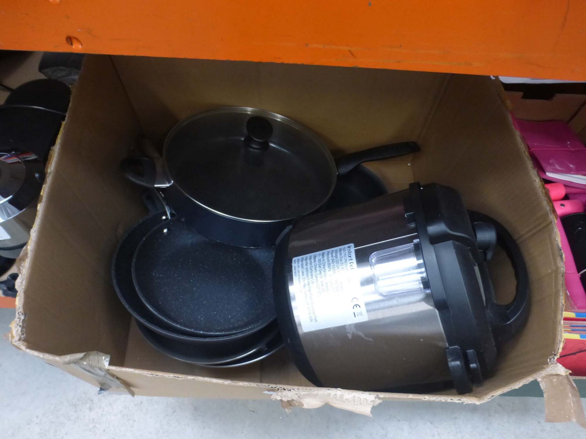 Box containing used pots and pans, and instant pot