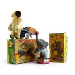 Two battery operated toys comprising: Circus Elephant with blowing ball and Cappy Baggage Porter,