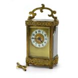A late 19th/early 20th century carriage timepiece in a brass, fretwork and five-glass case, h.