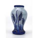 A miniature Moorcroft vase of baluster form decorated with grape hyacinth on a shaded blue ground,