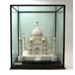 An ebonised and five-glass case containing a model of the Taj Mahal constructed from sugar with