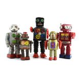 A Japanese battery operated tinplate robot and four further tinplate robots (5) *Proceeds of the