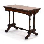 A Gillows side table, the walnut and ebonised top folding to reveal a baize covered games surface,