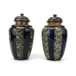 A pair of Doulton Lambeth covered vases of ovoid form,