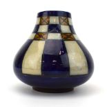 A Royal Doulton vase of squat form decorated with a blue, mustard and grey chessboard design, h.