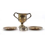 A mixed parcel of silver comprising a two handled miniature trophy vase,