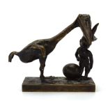 A brown patinated group modelled as a flying reptile, egg and grotesque figure, unsigned, h.