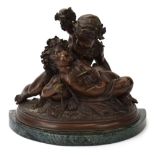 A 20th century bronzed figural group modelled as two putti with a goblet and grapes,