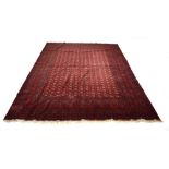 A Turkoman carpet with a red ground, numerous medallians and fine geometric bands,