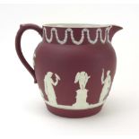 A Wedgwood crimson and white jasperware water jug typically decorated in the Neo-Classical manner,