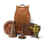 A group of brass and copper wares decorated in the Arts & Crafts manner including a beaten brass