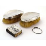A pair of silver backed hairbrushes, a silver mounted prayer book and a christening bracelet,