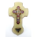 A Continental cloisonne enamelled cross and font mounted on an onyx and brass back,