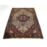 A Caucasian rug, the central medallian within a blue, cream and red ground,