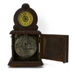A late 19th century German oak cased polyphon mantel clock, DRP 126993, h.