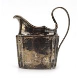 A Georgian Irish silver milk jug of traditional form, engraved in the Neo-Classical manner,
