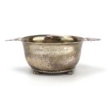 An early 20th century silver two handled porringer of typical form, Asprey, London 1919, w.