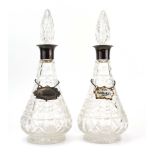 A pair of early 20th century silver mounted moulded glass decanters and stoppers,