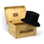 A Dunn & Co. black silk top hat, in the associated card case, 30/-, 19.5 x 16.