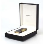 A cased Dunhill lighter with a white metal and black lacquered body,