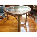 Plectrum shaped coffee table with central circular inset glass surface