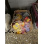 Box of colourful childrens mugs with names