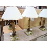 Pair of brass column shape table lamps with tapered white and gilt shades