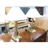 Pair of brass column shape table lamps with tapered white and gilt shades