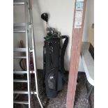Golf bag with assorted Palmer and other golf clubs