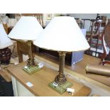 Pair of brass column shape table lamps with tapered white and gilt shades