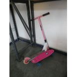 Childs scooter with small pink skateboard