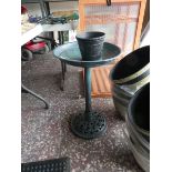 Green plastic bird table with flower pot