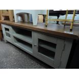 (Q) Wide entertainment unit with 2 glazed cupboards flanking centre shelf with oak top