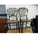 Pair of ebonized chairs with applied gilt, mother of pearl decoration and bergere seats