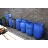 8 large blue and black plastic barrels with 7 small blue plastic barrels