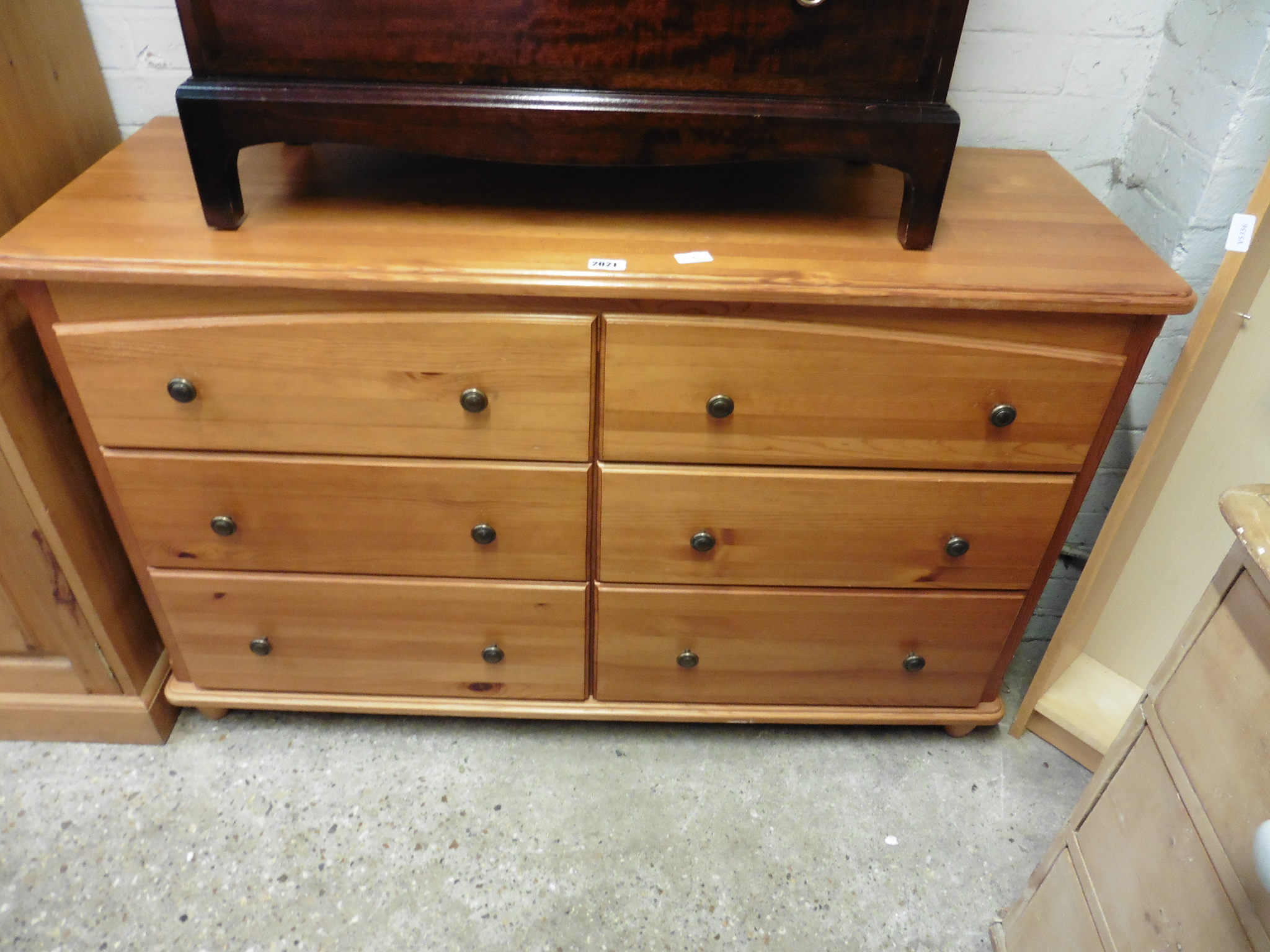 Stained pine wide chest of 6 drawers