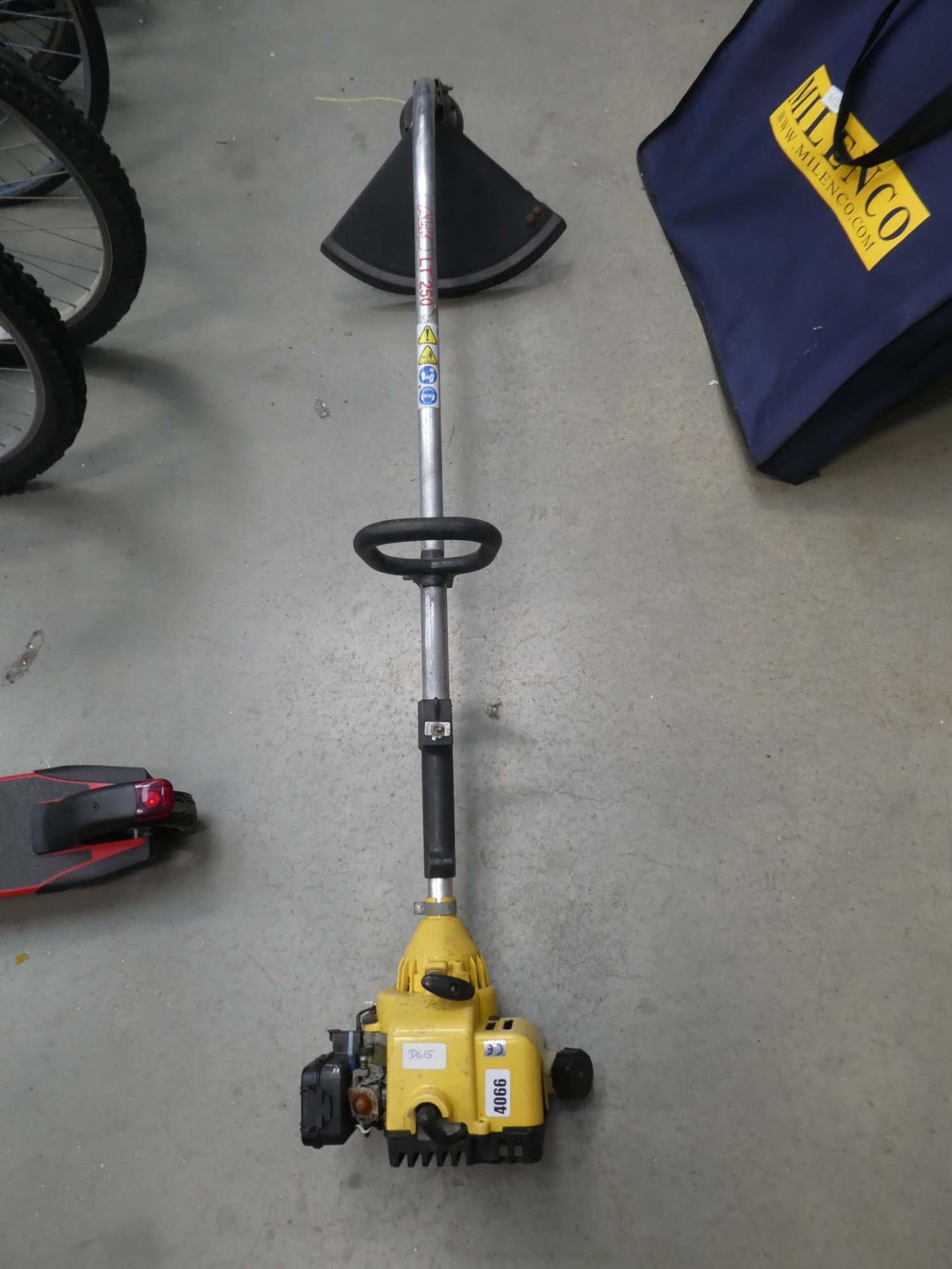 Yellow bent shaft petrol powered strimmer