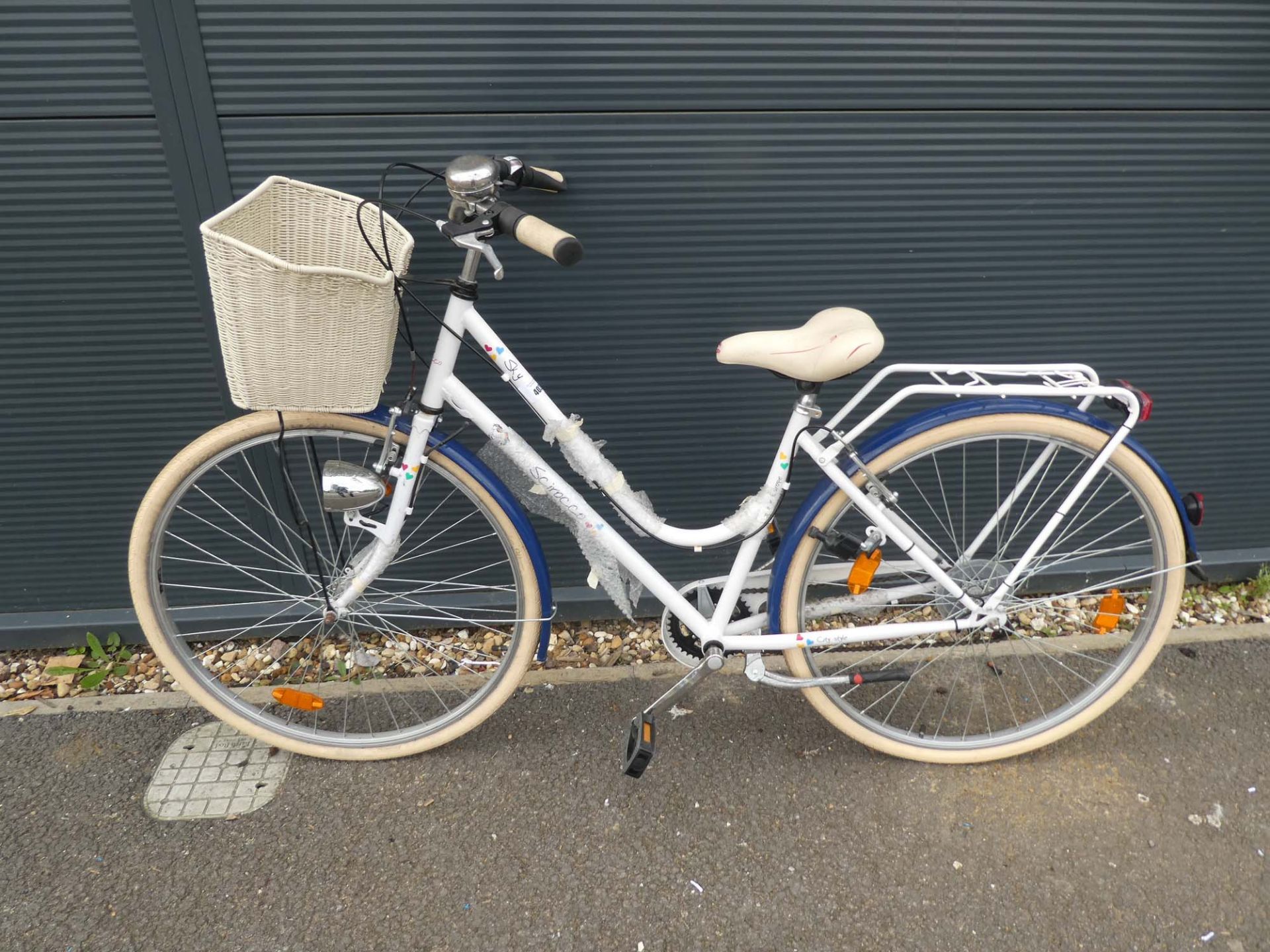 White and blue ladies bike with front basket